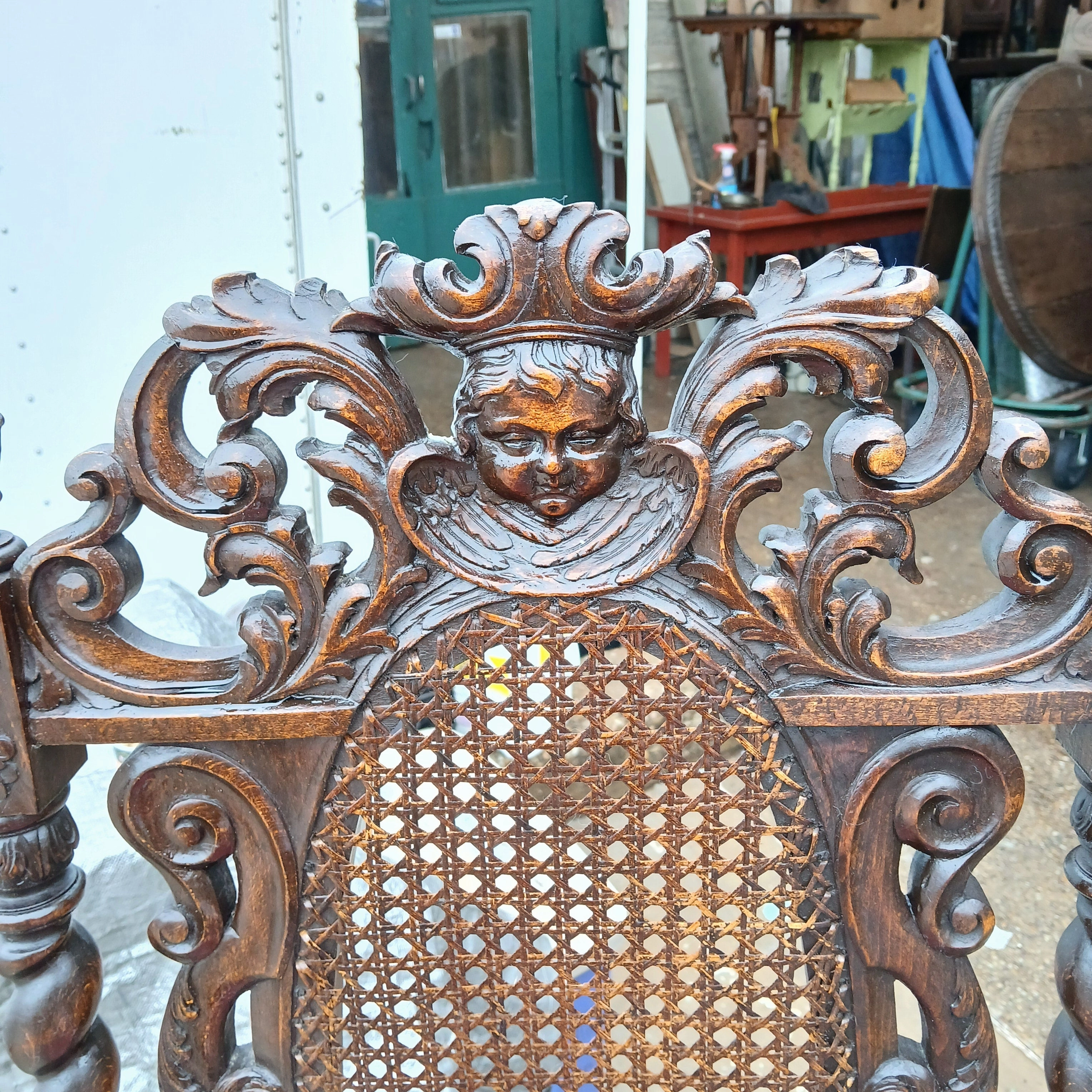 CARVED OAK BARLEY TWIST ARM CHAIR WITH CHERUB CREST