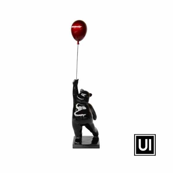 Large black bear holding red balloon